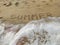 Sea waves on the beach. The inscription on the sandy shore `SUMMER`