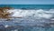 Sea waves break against the rocky coastline in Sierra de Irta Natural Park, Castellon, Spain