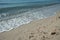 Sea waves bubbles on the beach