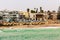 Sea waves, coastline, cars and buildings on the street of Swakopmund German colonial town, Namibia