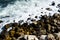 Sea waves crashing on rocks coast and the sea foam.