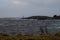 Sea with waves hitting coastline with lighthouse 