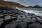 Sea waves hitting the natural hexagonal stones at the coast called Giant`s Causeway, a landmark in Northern Ireland, with the