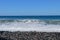 Sea waves hitting the stony coast. Waves turn into sea foam. Frothy sea water and bubbles. The Azores kill water. Background