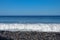 Sea waves hitting the stony coast. Waves turn into sea foam. Frothy sea water and bubbles. The Azores kill water. Background