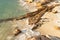 Sea waves impact rock on the beach