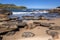 Sea waves lash line impact rock on the beach