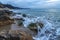 Sea waves over the rocks and splash of seawater at morning on the shore of the Black Sea