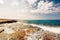 Sea waves and rocks at sunset, creamy water and clear skies on a beautiful summer day