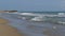 The Sea Waves are Rolling on a Sand Beach in Slow Motion