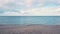 Sea waves on sand beach and beautiful artistic sky with cloud, overcast day. Sea of Azov empty beach.