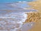 Sea waves on sand and pebbles beach