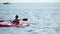 Sea woman kayak. Happy woman in life jacket paddling the kayak on sea. Female is enjoying her summer vacations at beach