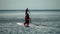 Sea woman and man sup. Silhouette of happy young woman and man, surfing on SUP board, confident paddling through water