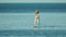 Sea woman sup. Silhouette of happy middle aged woman standing, surfing on SUP board, confident paddling through water