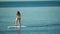 Sea woman sup. Silhouette of happy middle aged woman standing, surfing on SUP board, confident paddling through water