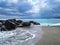 Sea â€‹â€‹coast with rocks after a storm, black clouds in the sky.