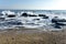 Sea â€‹â€‹landscape with sea waves falling on the rocks scattered along the seashore