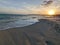 sea â€‹â€‹water rising on the sand on the shore of the beach in the sunset