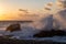 Sea â€‹â€‹wave at sunset hitting  rock on the beach