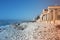 Sea â€‹â€‹with sandy beach and rocks with a view of the fiat tower in massa carrara in tuscany in front of the don gnocchi