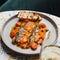 Seabass Neapolitan style with tomatoes and capers, copy space. food concept