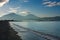 Seacoast on background of mountains and blue sky at dawn