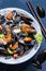 The seafood with black pasta, mussels, shrimp and vegetables