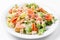 Seafood caesar salad with shrimps, croutons, salad leaf, parmesan cheese and salmon