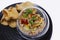 seafood ceviche or tartare in a glass bowl with crackers with white background