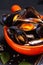 Seafood concept Mussels in orange handle bowl on black slate stone with copy space