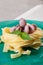 Seafood Fettuccine pasta with octopus, garnished with basil on a clay plate and fabric background