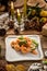 Seafood Green Salad with Salmon, Avocado and Shrimps on white plate on christmas decorated background