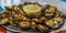 Seafood - grilled limpets served with lemon. Lapas grelhadas