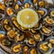 Seafood - grilled limpets served with lemon. Lapas grelhadas