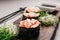 Seafood gunkan maki sushi rolls on wooden plate