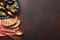 Seafood mussels and basil leaves in a black plate with towel, bread slices, wooden spoon and fork on rusty background