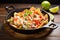 seafood nachos with shrimp and lime wedges