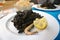 Seafood paella with black squid ink
