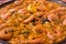 Seafood paella closeup. Delicious seafood meal. Mediterranean cuisine. Paella pan with king shrimps, mussels, saffron and calamari