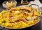 Seafood Paella Meal with Lemon Wedges and Oil