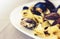 Seafood pasta spaghetti linguine wish mussels, clams, cherry tomatoes, fresh parmesan on the white plate in restaurant in Catania