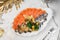 Seafood platter with salmon fillet, pangasius fish, herring, decorated with olives and lemon on marble background