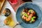 Seafood risotto black on plate on a wooden background, top view