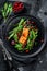 Seafood salad with trout, arugula, lettuce and cranberries. Black background. Top view