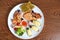 Seafood of salmon, caviar, mussels, fried shrimp, cherry tomatoes, lemon, lettuce and olives, close up, flat lay, top view