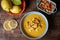 Seafood soup, based on prawns, mussels, clams, hake and squid, served with fried bread and lemons, on a dark wooden table.