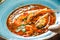 Seafood soup with langoustine, mussels, squid, scallops, fennel, sweet pepper, shrimp on dark wooden background, healthy food