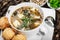 Seafood Soup with salmon, cheese, seaweed, sesame and bread on plate on wooden background.