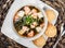 Seafood Soup with salmon, cheese, seaweed, sesame and bread on plate on wooden background. Mediterranean food.